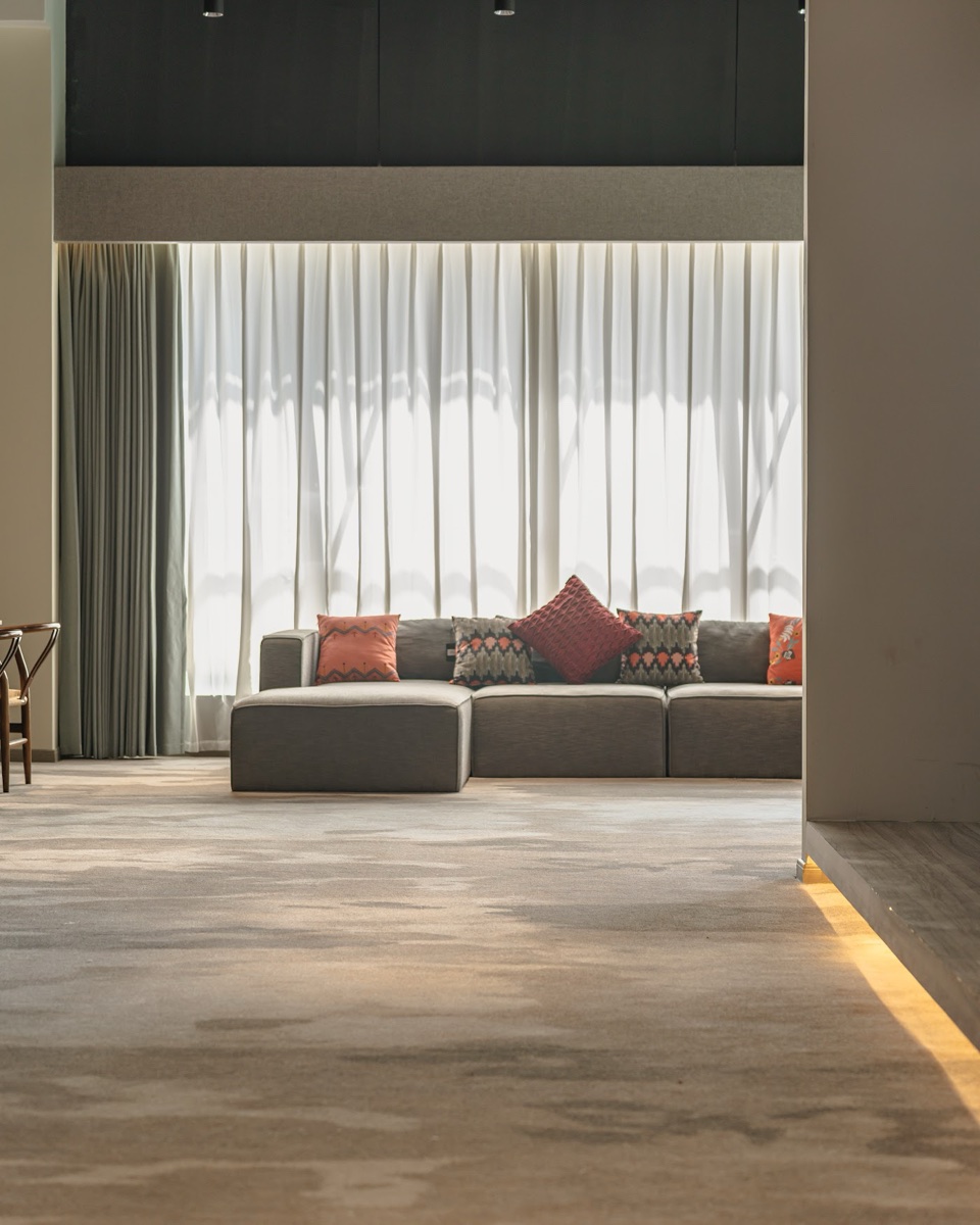 Material Supply Pro showroom lounge with curtains and commercial carpet